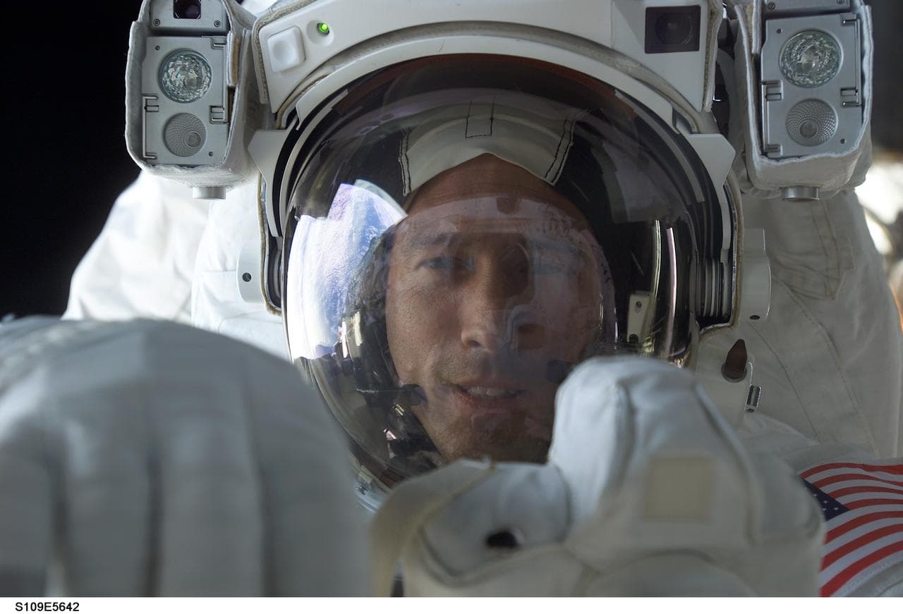 EVA 2 - MS Newman with camera