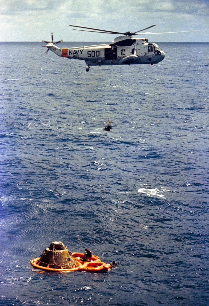 Astronaut Stuart Roosa hoisted inside recovery net to Navy helicopter