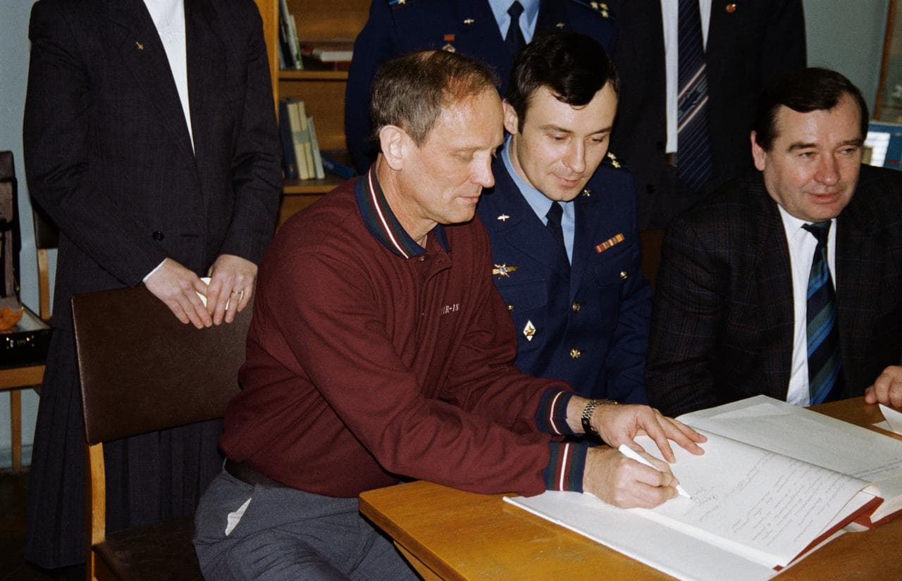 Astronauts & cosmonauts sign Gagarin's diary