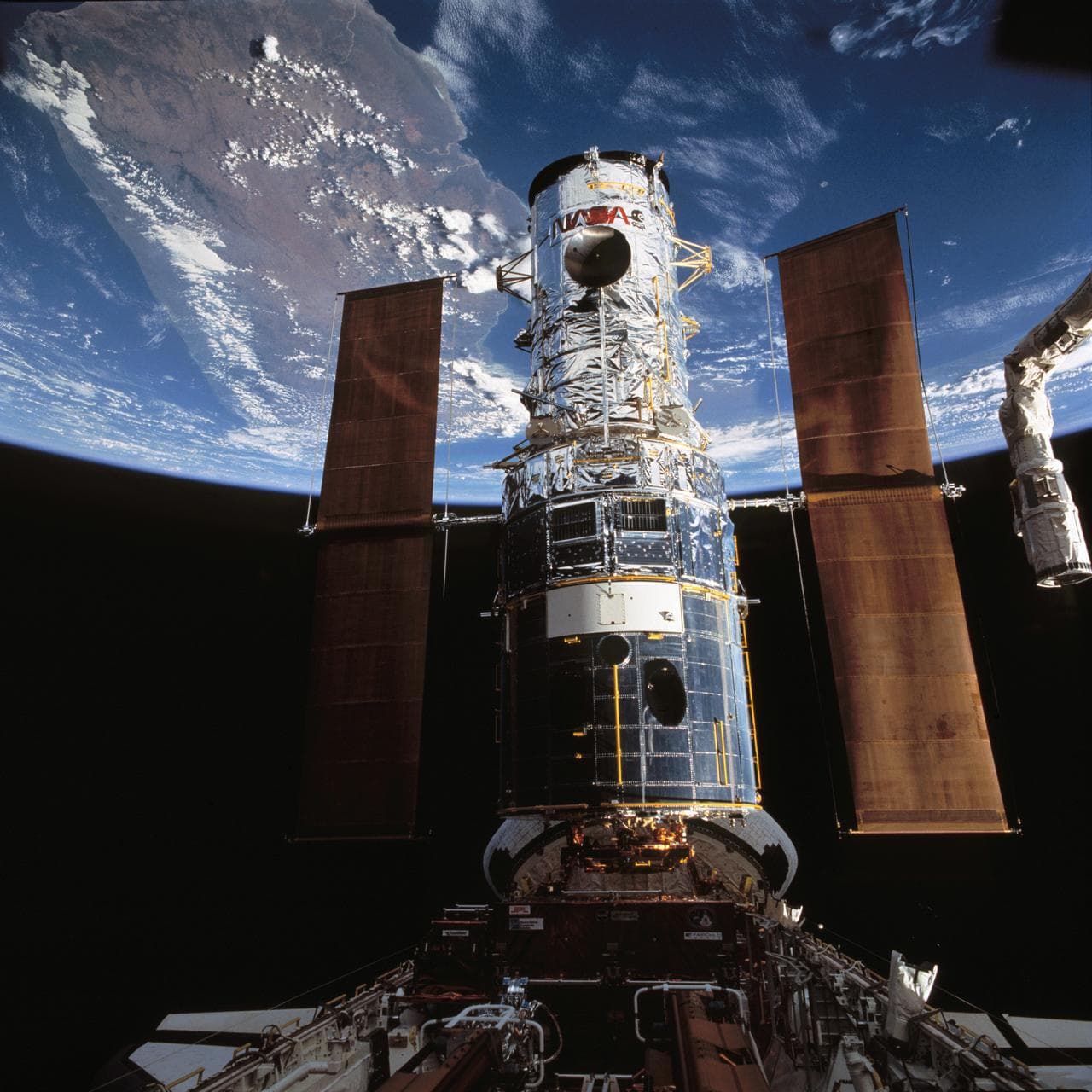 Hubble Space Telescope is berthed in Endeavour's payload bay after capture