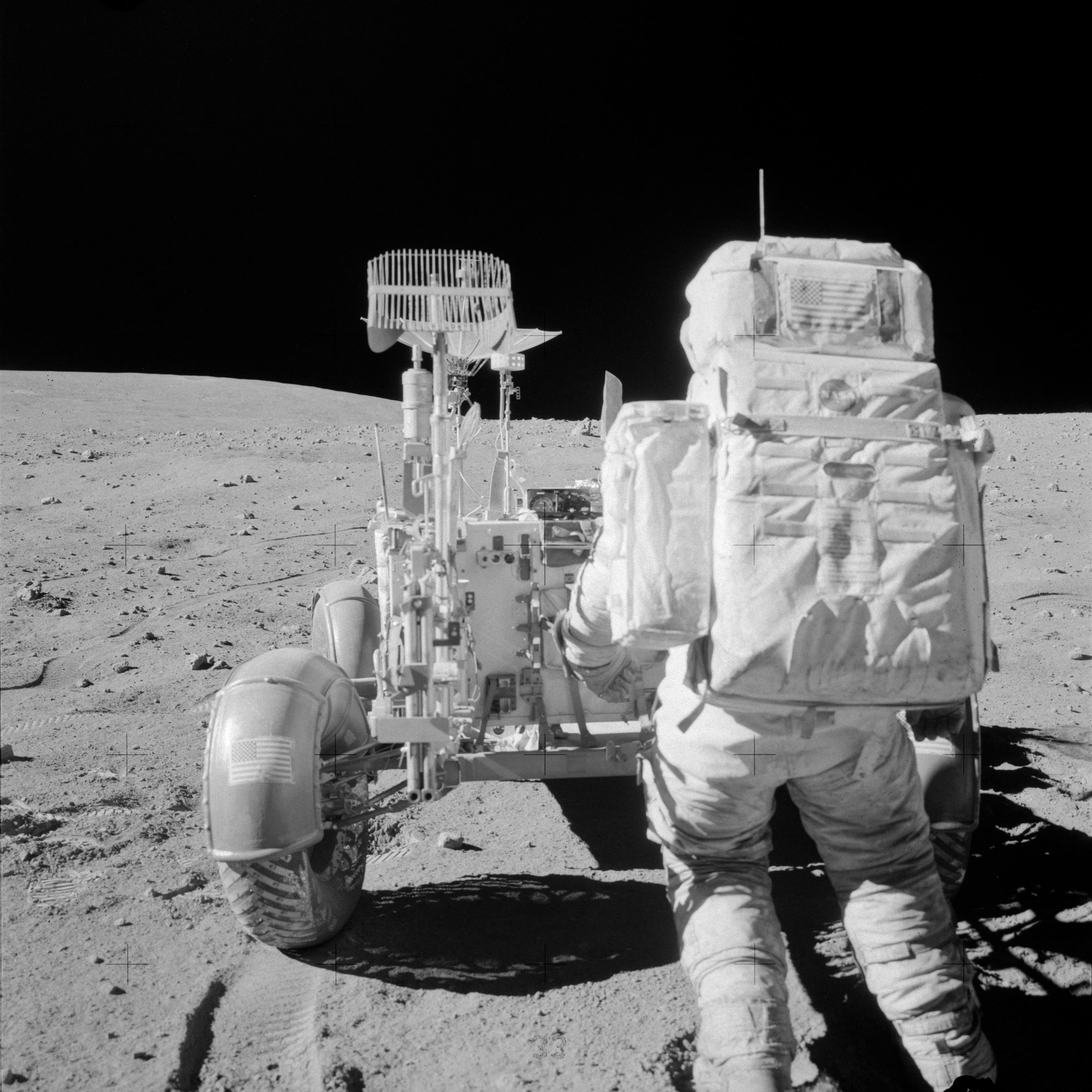 Astronaut John Young reaches for tools in Lunar Roving Vehicle during EVA