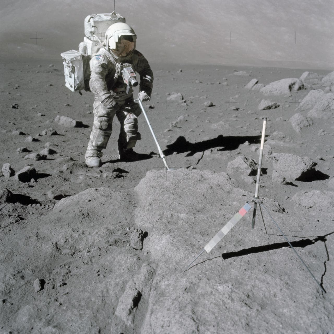 Astronaut Harrison Schmitt uses scoop to retrieve lunar samples during EVA
