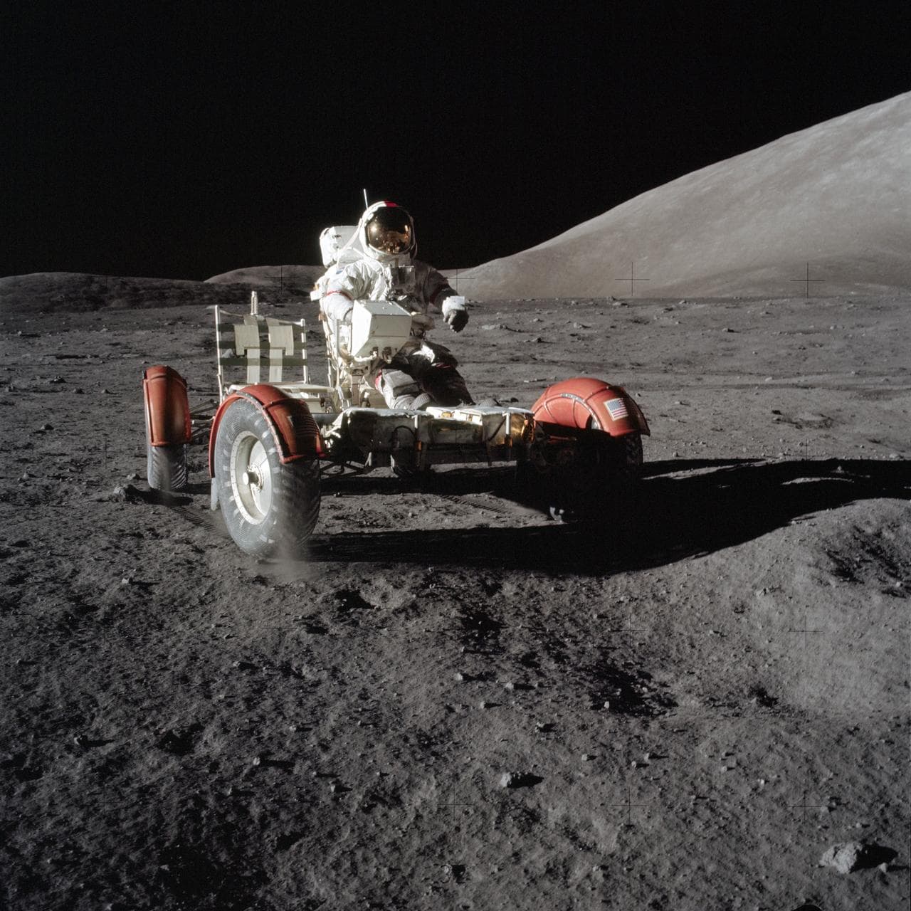 Astronaut Eugene Cernan drives the Lunar Roving Vehicle during first EVA