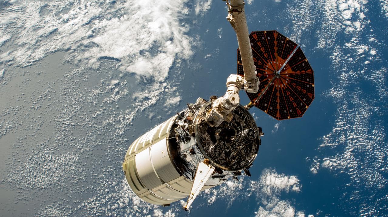 The Cygnus space freighter in the grip of the Canadarm2 robotic arm