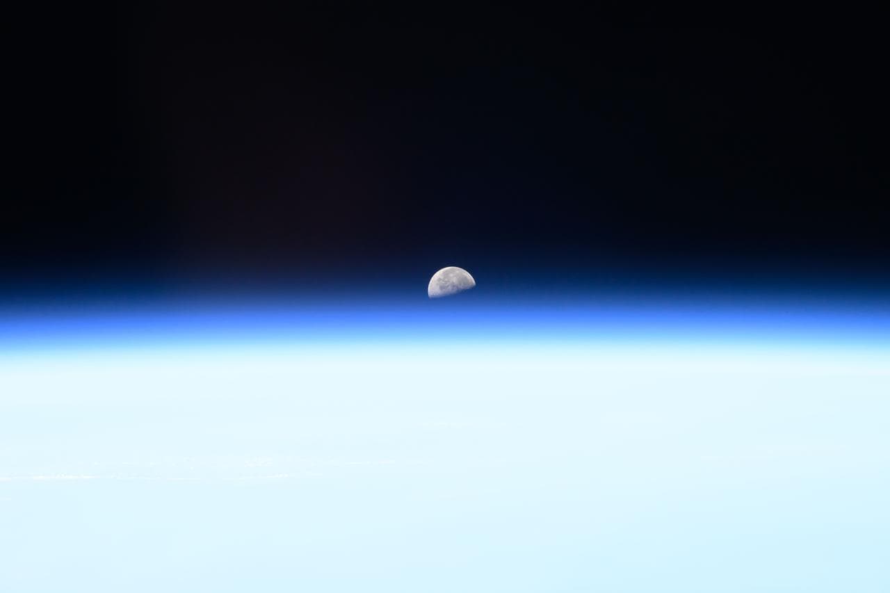 The third quarter Moon rises above Earth