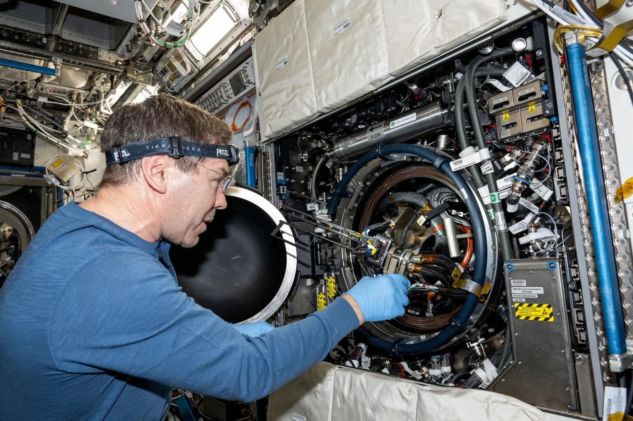 Astronaut Mike Barratt replaces fuel bottles inside the Combustion Integrated Rack