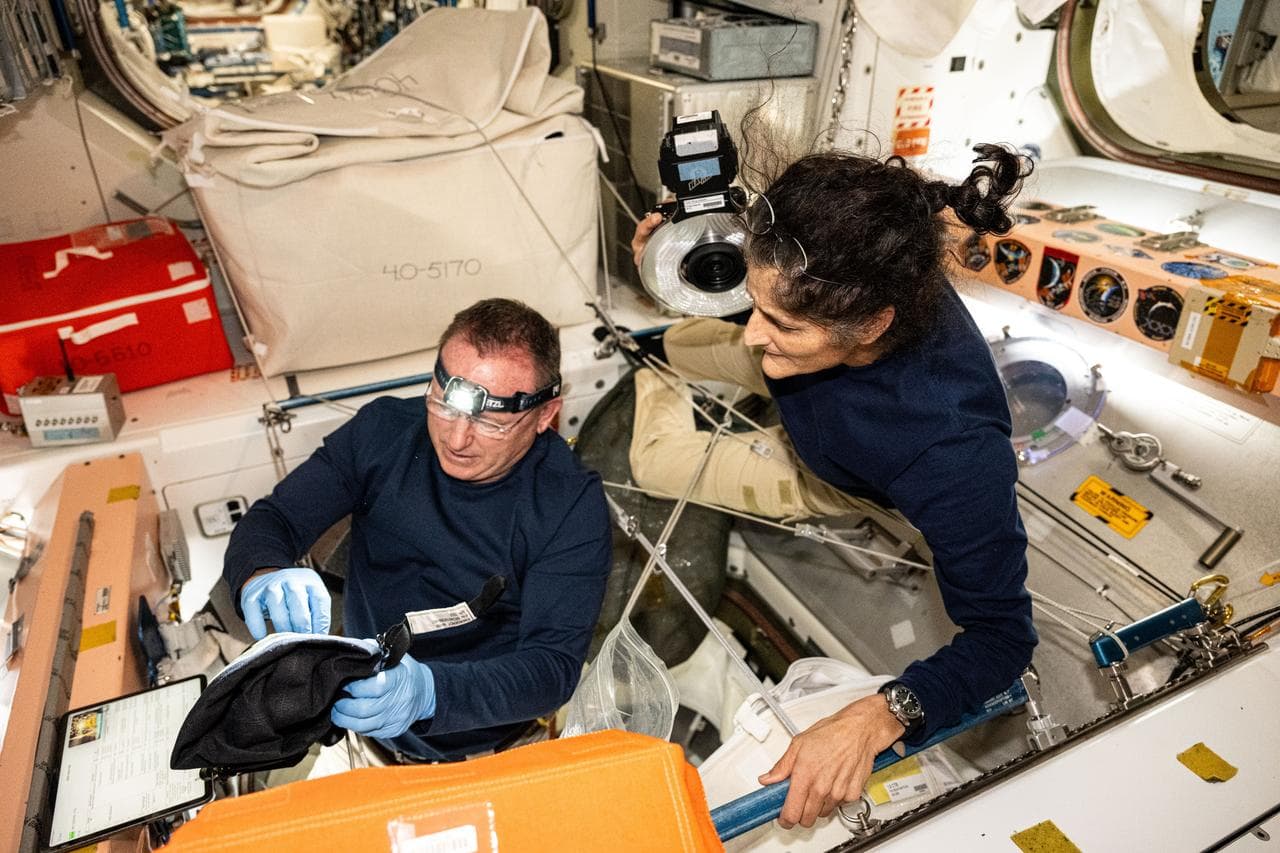 Astronauts Butch Wilmore and Suni Williams inspect safety hardware