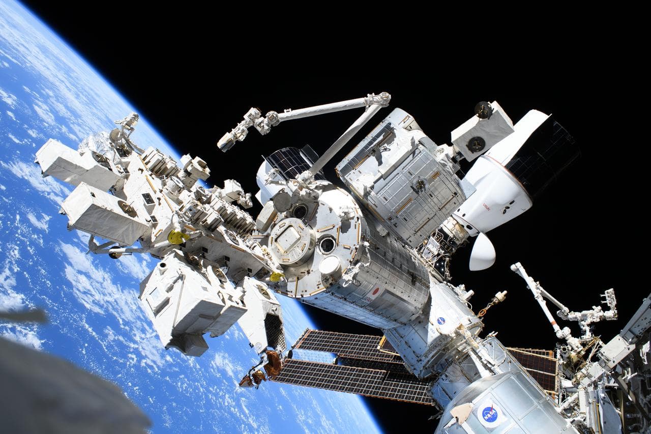 The forward portion of the International Space Station with Kibo and the SpaceX Dragon
