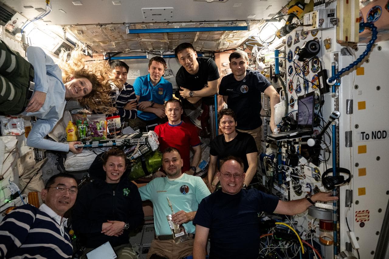 Eleven International Space Station crew members gather for a portrait