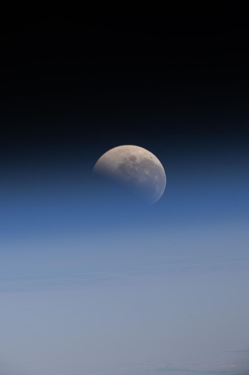 The lunar eclipse, also known as the Blood Moon, above Earth's horizon