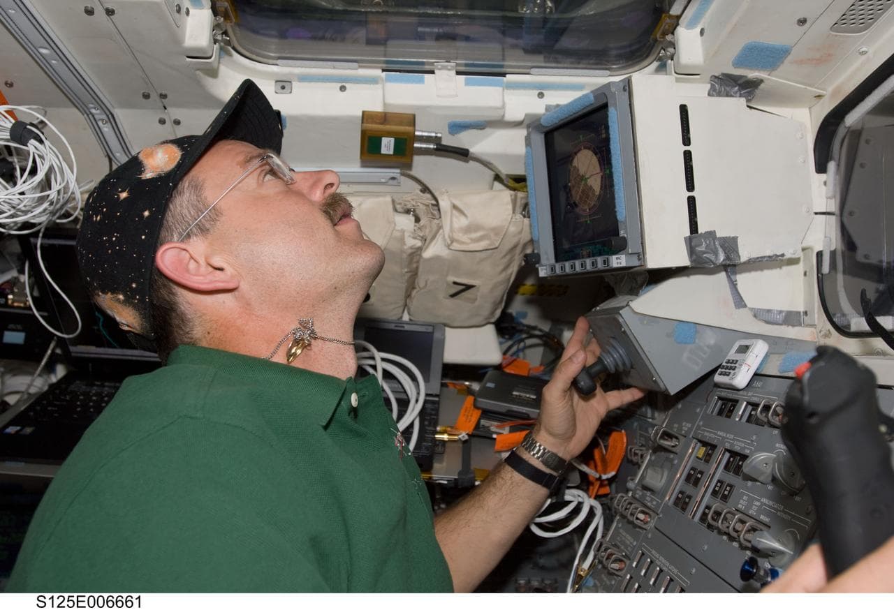  STS-125 Crew working on the Shuttle Atlantis Flight Deck during HST Rendezvous