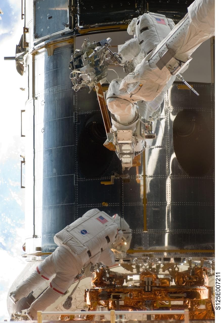STS-125 MS5 Feustel and MS3 Grunsfeld during EVA1