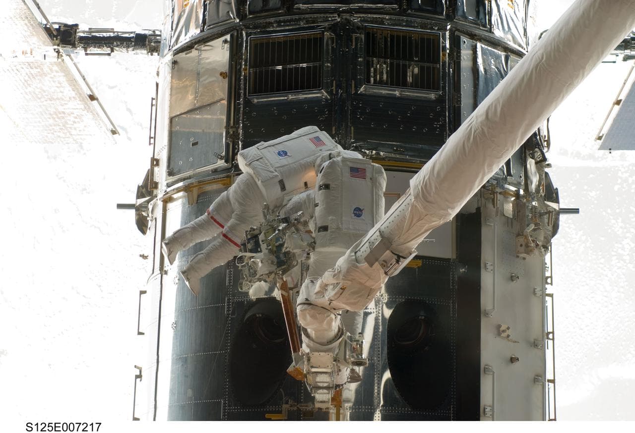 STS-125 MS5 Feustel and MS3 Grunsfeld during EVA1