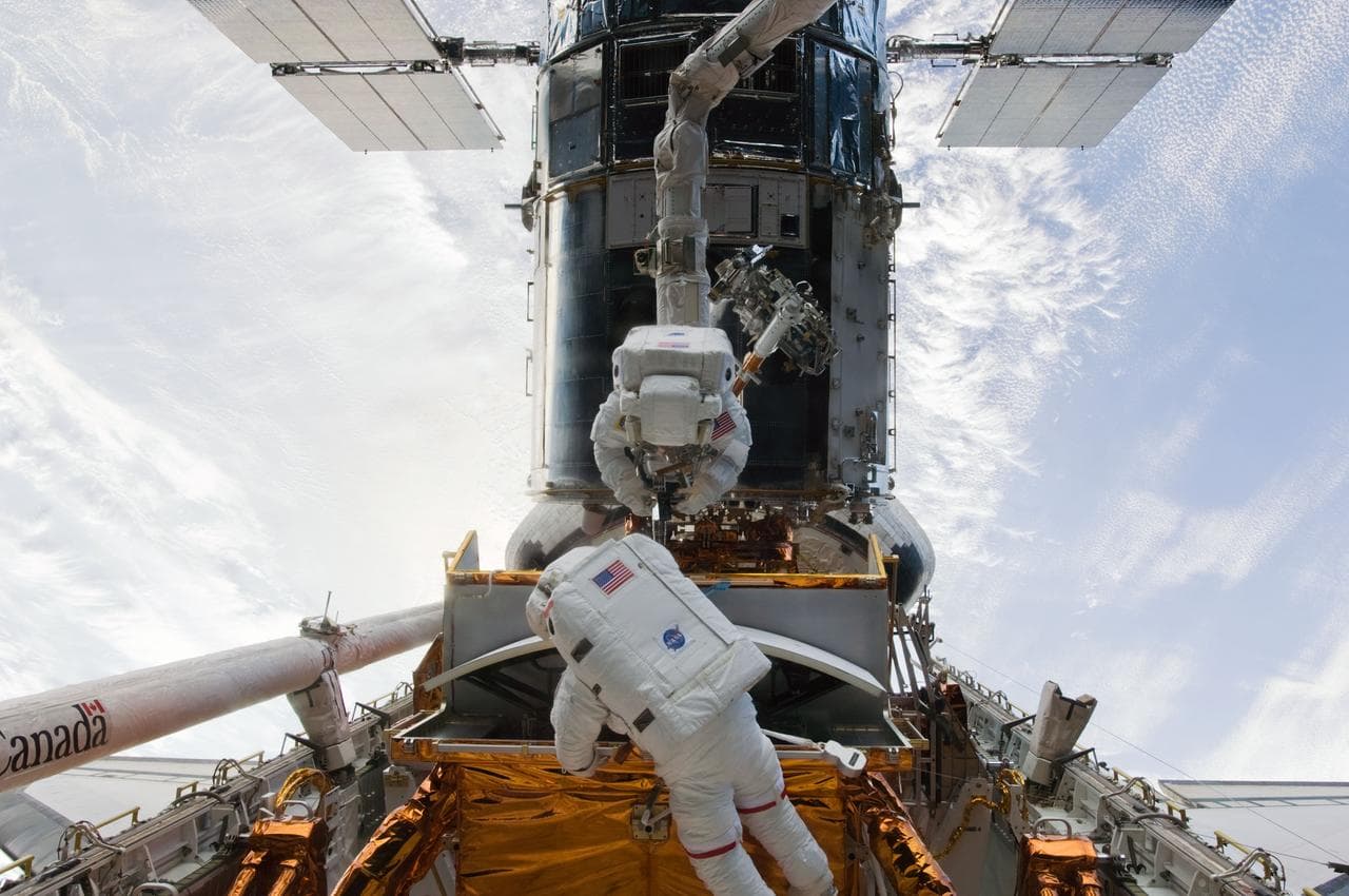 STS-125 MS5 Feustel and MS3 Grunsfeld during EVA1