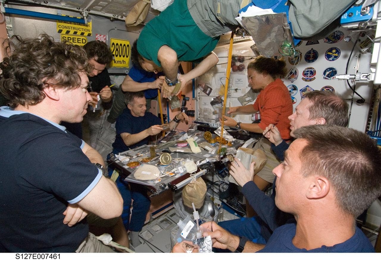 STS-127 / Expedition 20 Crewmembers eating in the Node 1 during Joint Operations