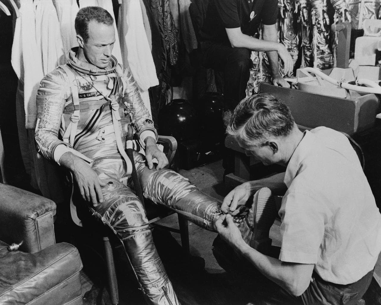 Astronaut Scott Carpenter and technician Joe Schmitt during suiting exercise