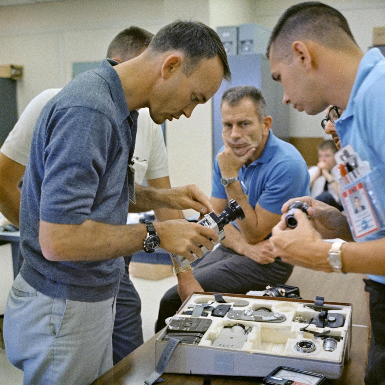 Astronaut Michael Collins inspects camera during prelaunch activity
