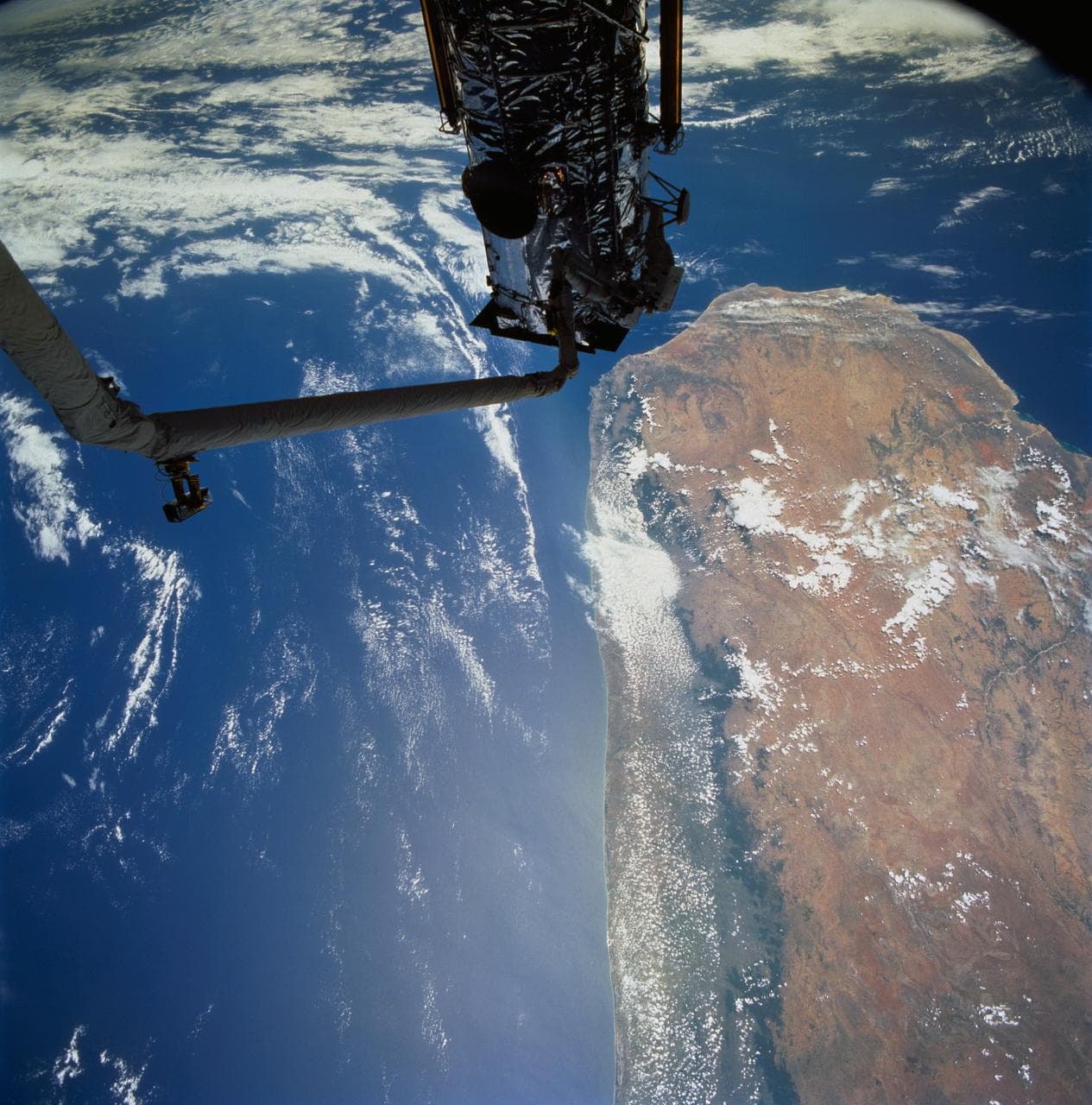 Astronauts Hoffman and Musgrave install the Magnetic Sensing System on HST