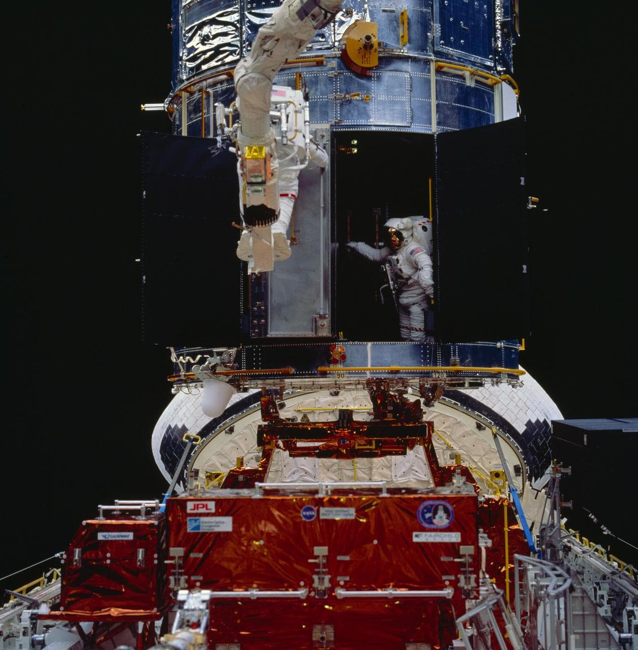 Astronauts Akers and Thornton install COSTAR during EVA for HST repair