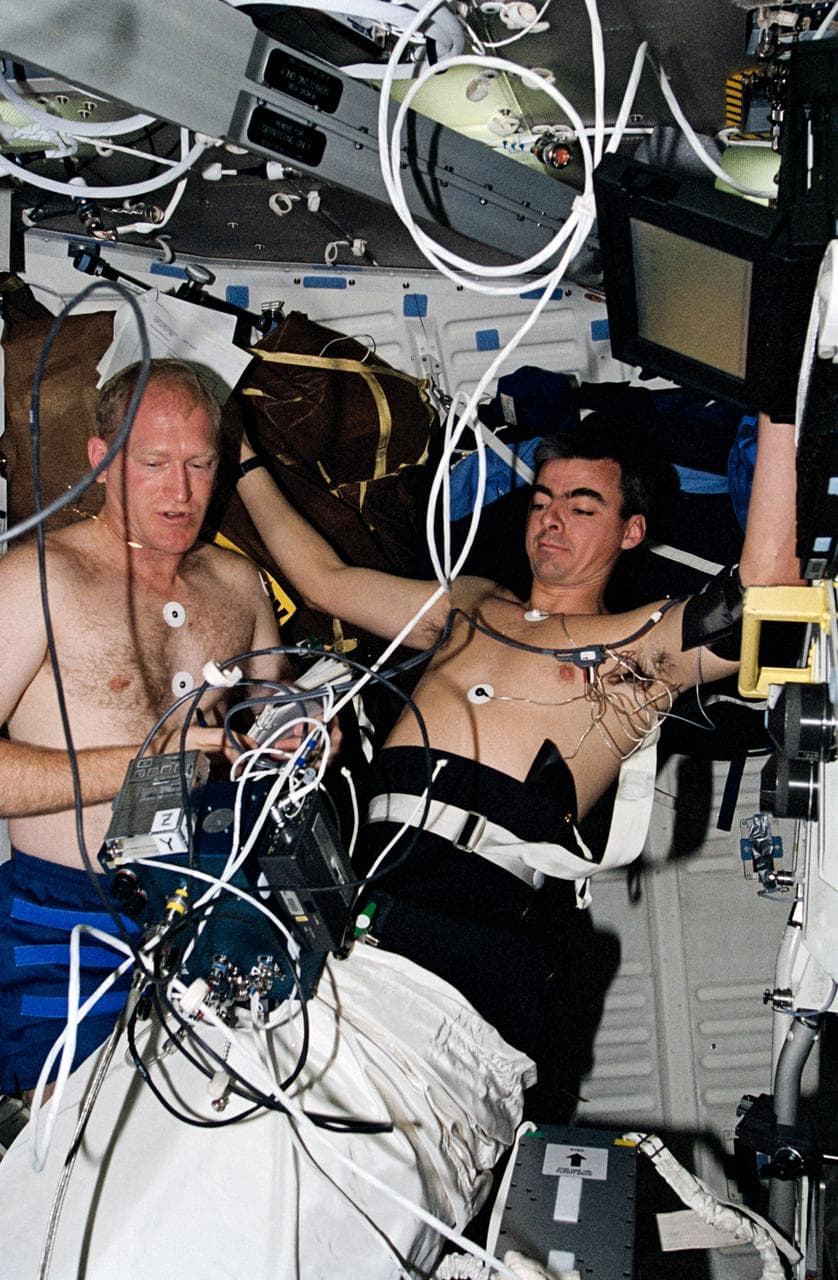 Astronauts Gemar and Allen work with lower body negative pressure experiment