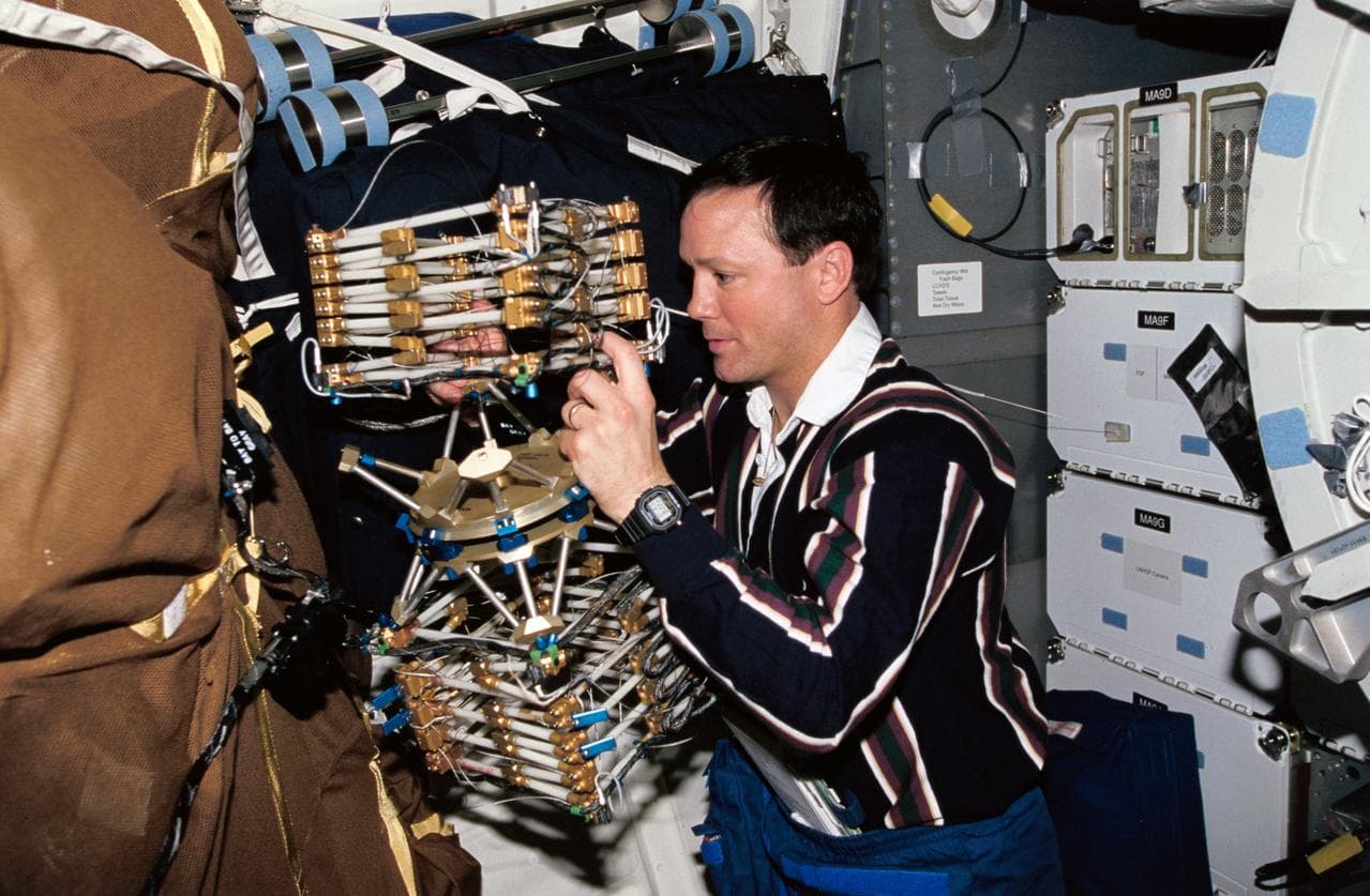 Astronaut Pierre Thuot works with Middeck O-Gravity Dynamics Experiment