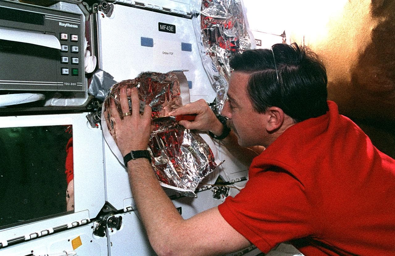 Horowitz fashions MLI patches on Flight Day 7